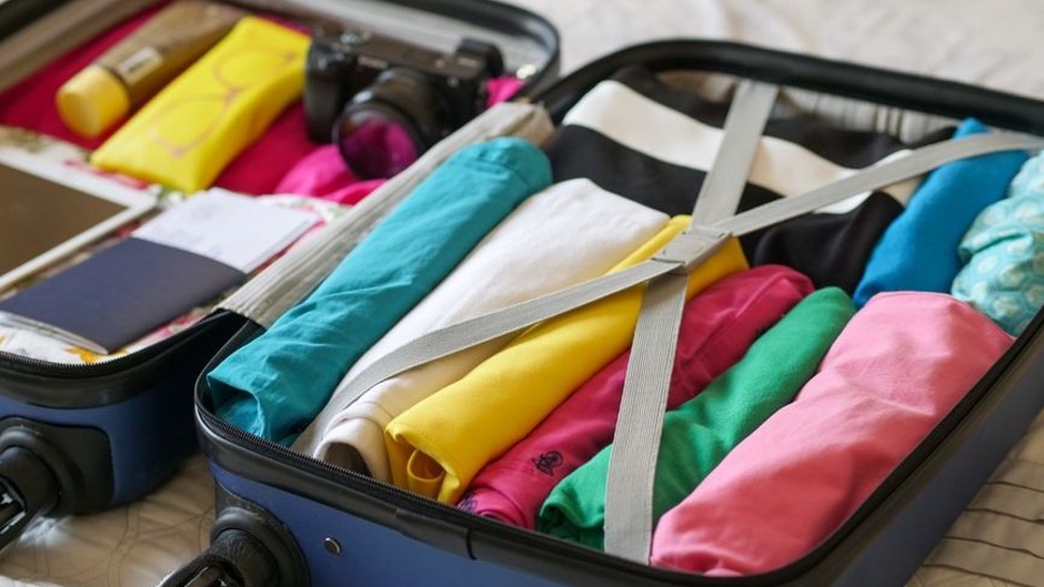 A neatly packed suitcase prepared for a light, practical trip.