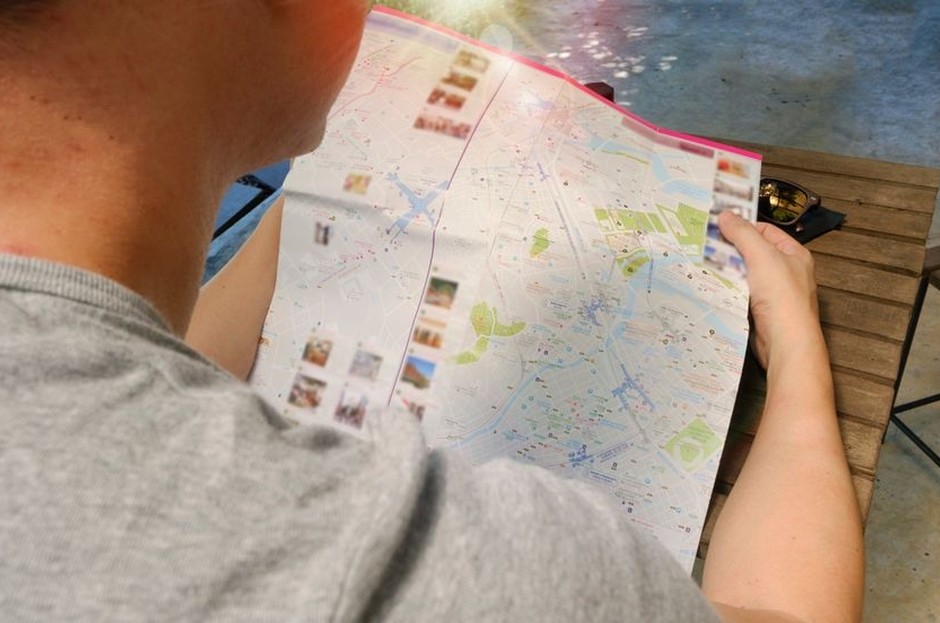 A person studying a city map before a walk